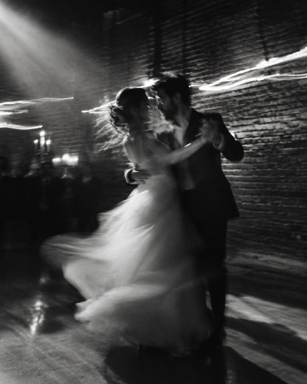 Couple dancing in a dim hall, long exposure